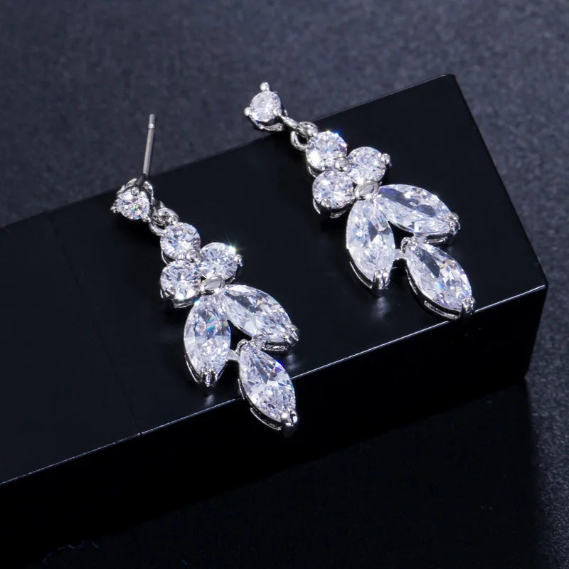 Pair of silver-tone cubic zirconia marquise drop earrings on black box