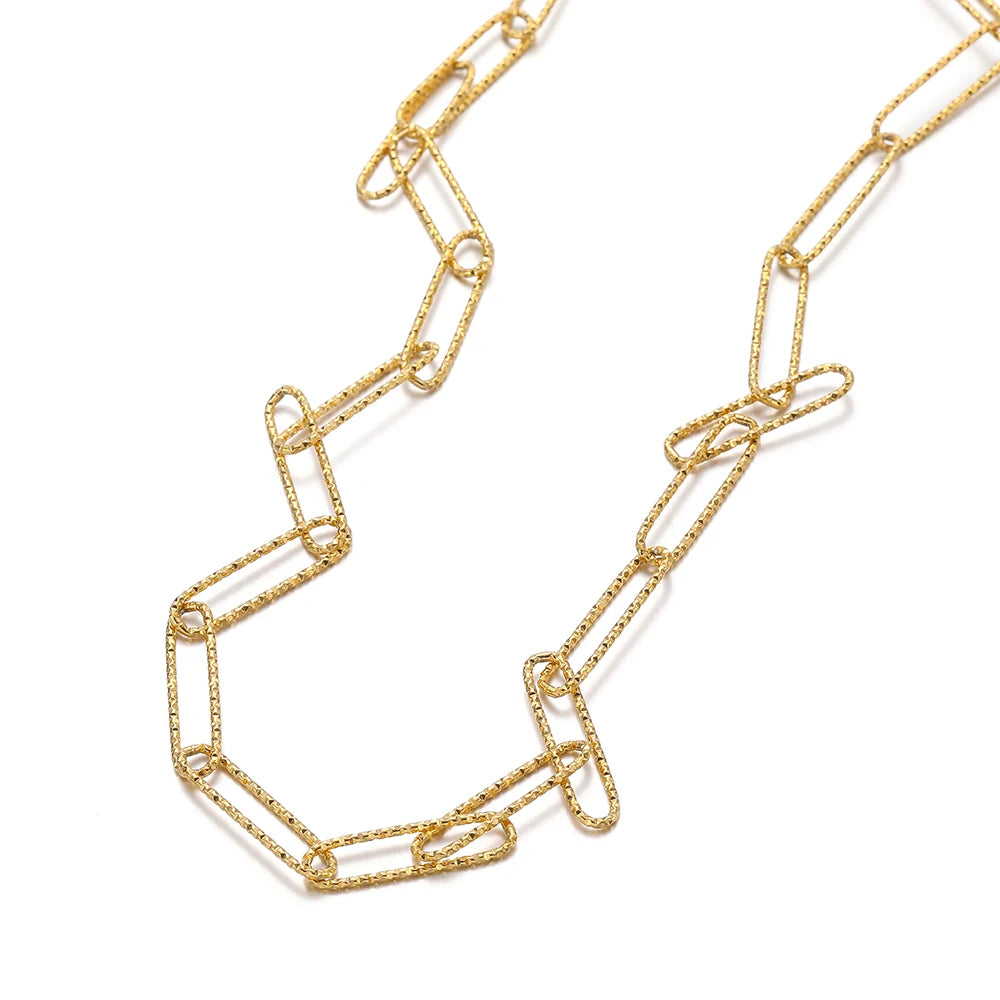 Gold oval link chain forming a curved section with connected rectangle-style links