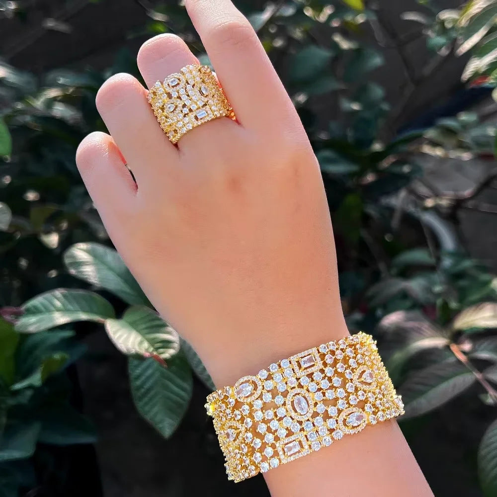Gold-tone cubic zirconia cuff bracelet and wide matching ring worn on hand
