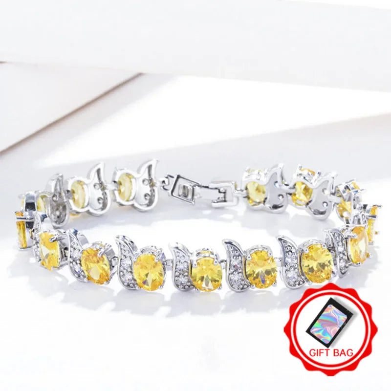 Yellow oval crystal tennis bracelet with silver-tone leaf accents and clasp