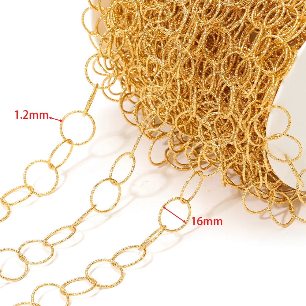 Gold hollow oval chain links close-up, thin ring texture from a spool