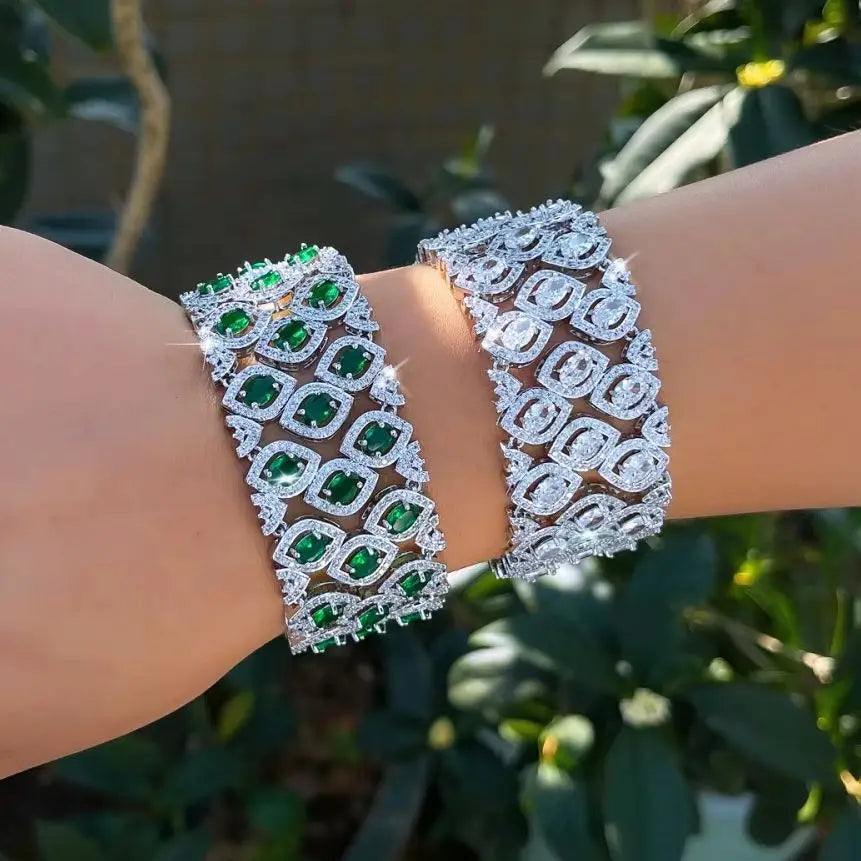 Green and clear zirconia wide bracelets worn on a wrist