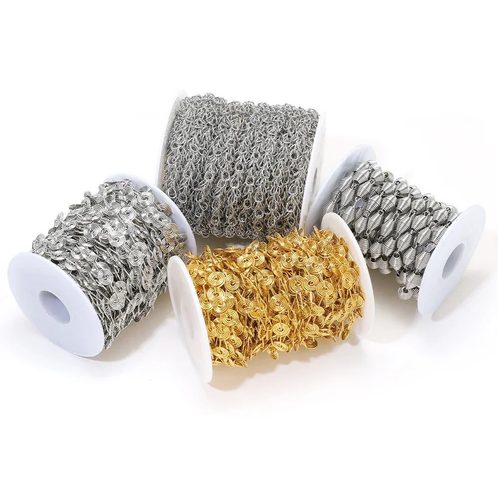 Three color metal chain rolls: silver, gold, and gray spiral links