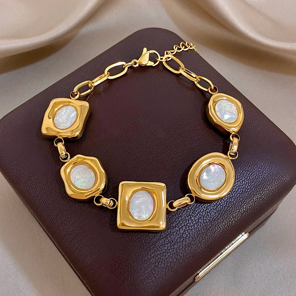 Gold-plated geometric shell bead bracelet with alternating square and oval white inlays