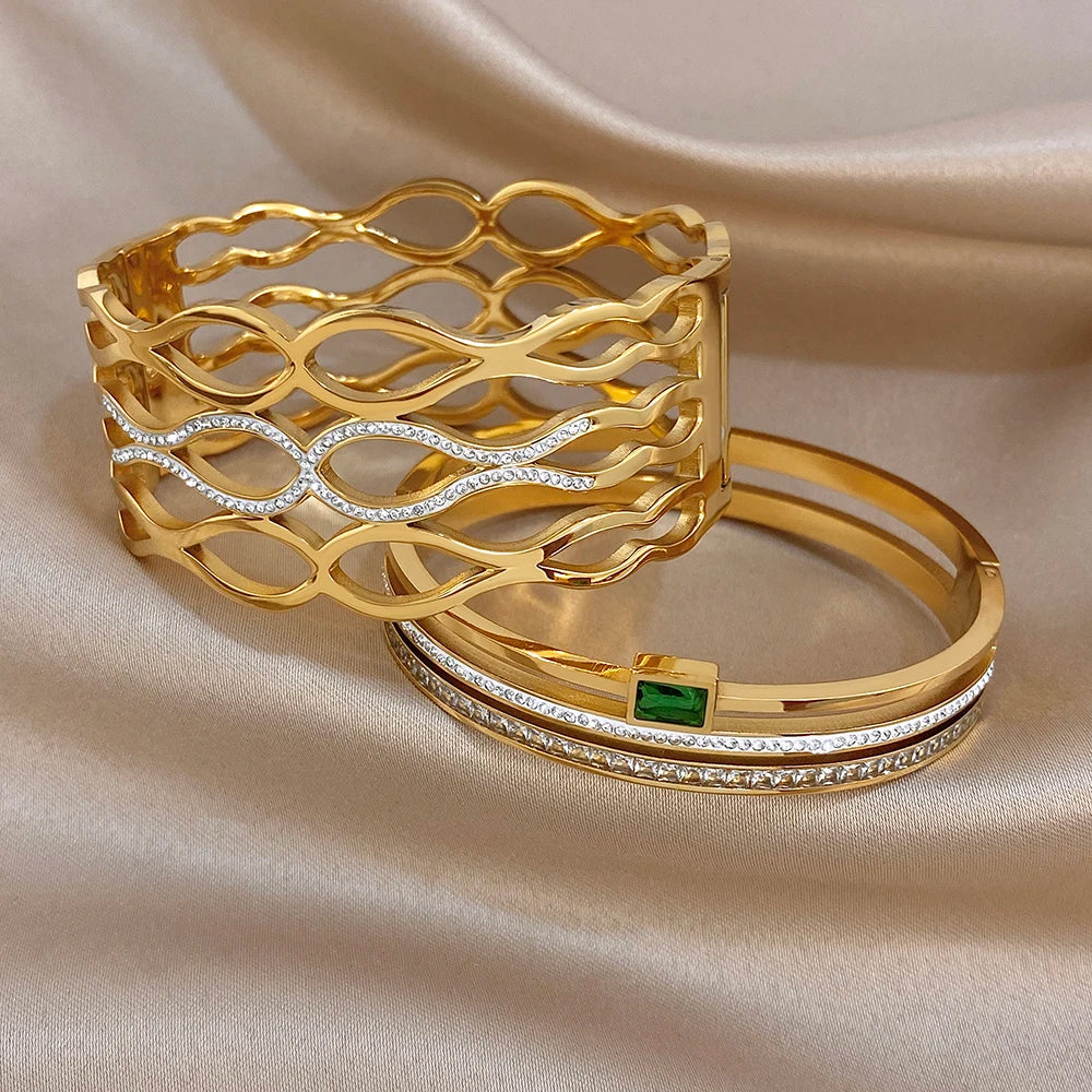 Gold-tone filigree cuff bracelet with oval-cut clear stones and green square accent bangle