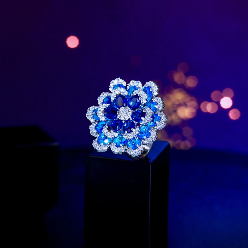 Blue flower ring with a large layered stone setting and silver-tone band
