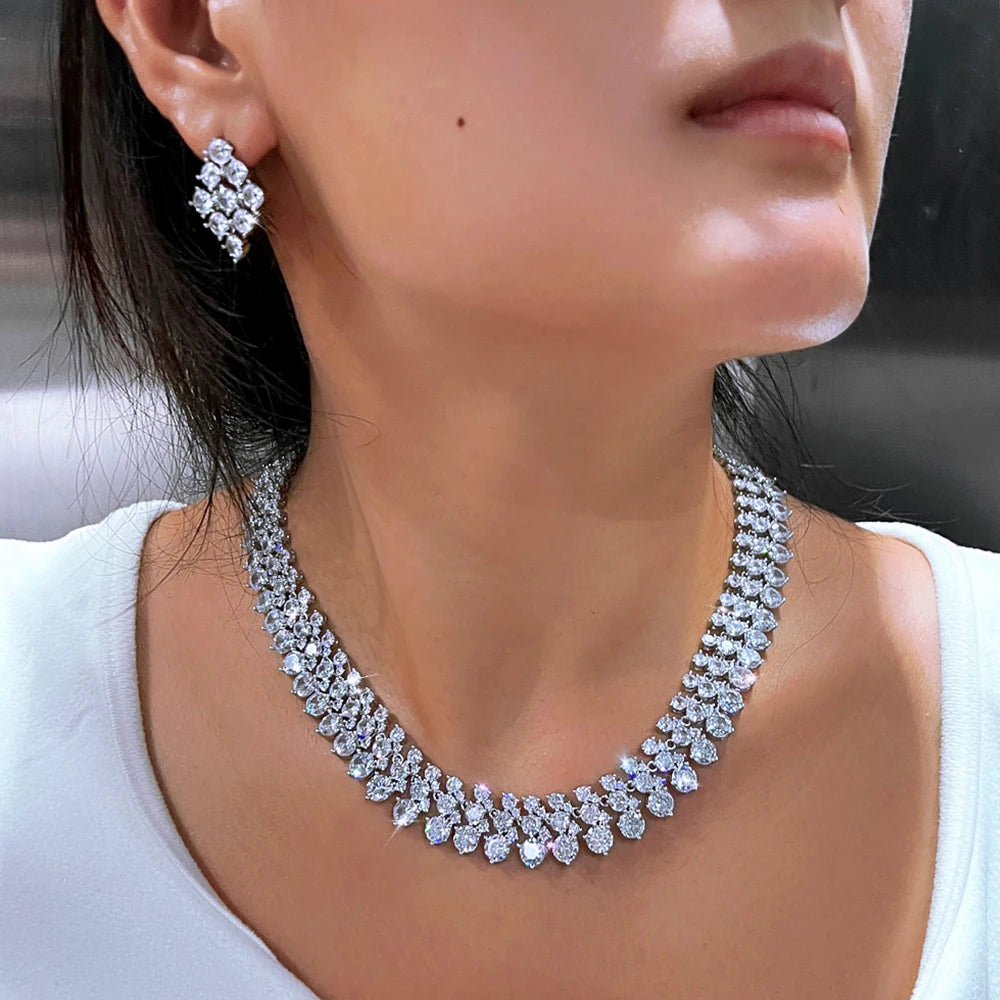 Silver-tone CZ cluster necklace with square stud earrings on model, side view