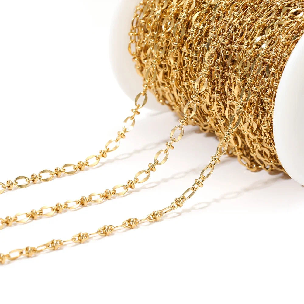 Gold embossed oval link chain bulk on a white spool with dangling links