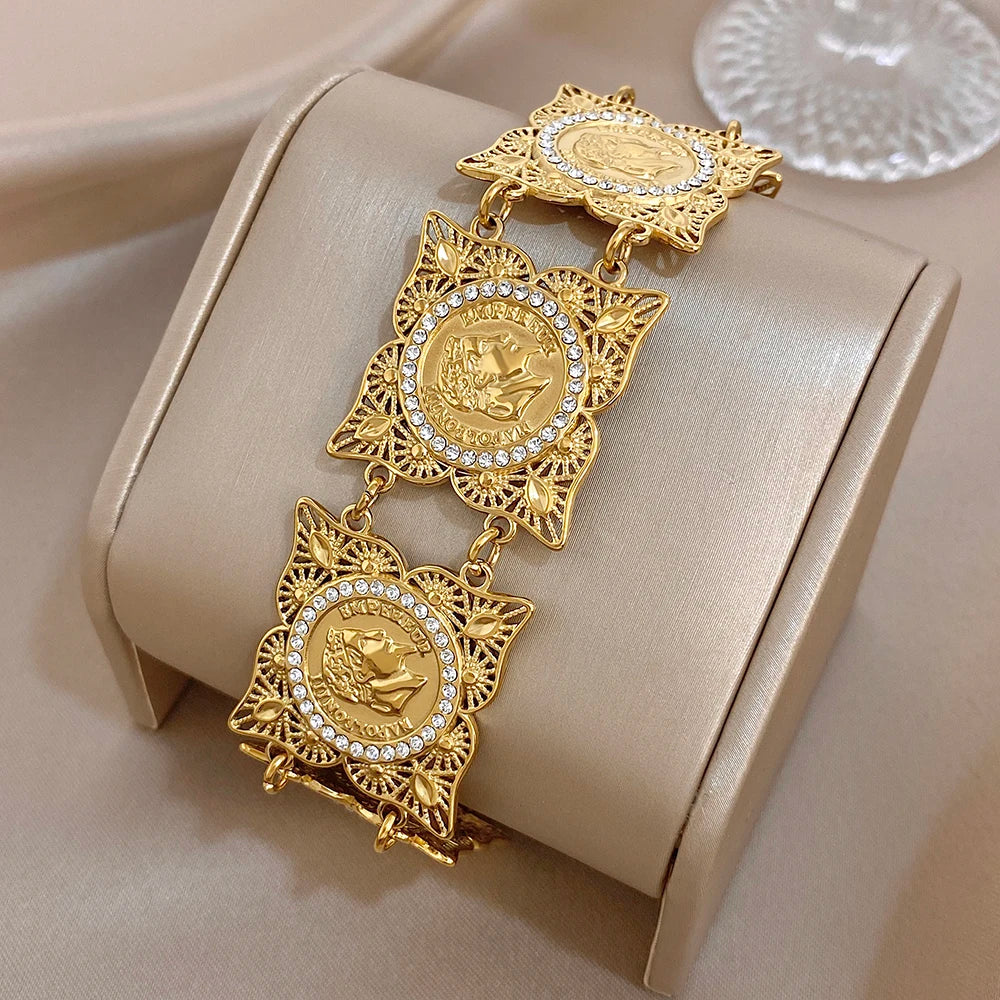 Gold-tone coin rhinestone bracelet with large star-shaped medallions and link chain
