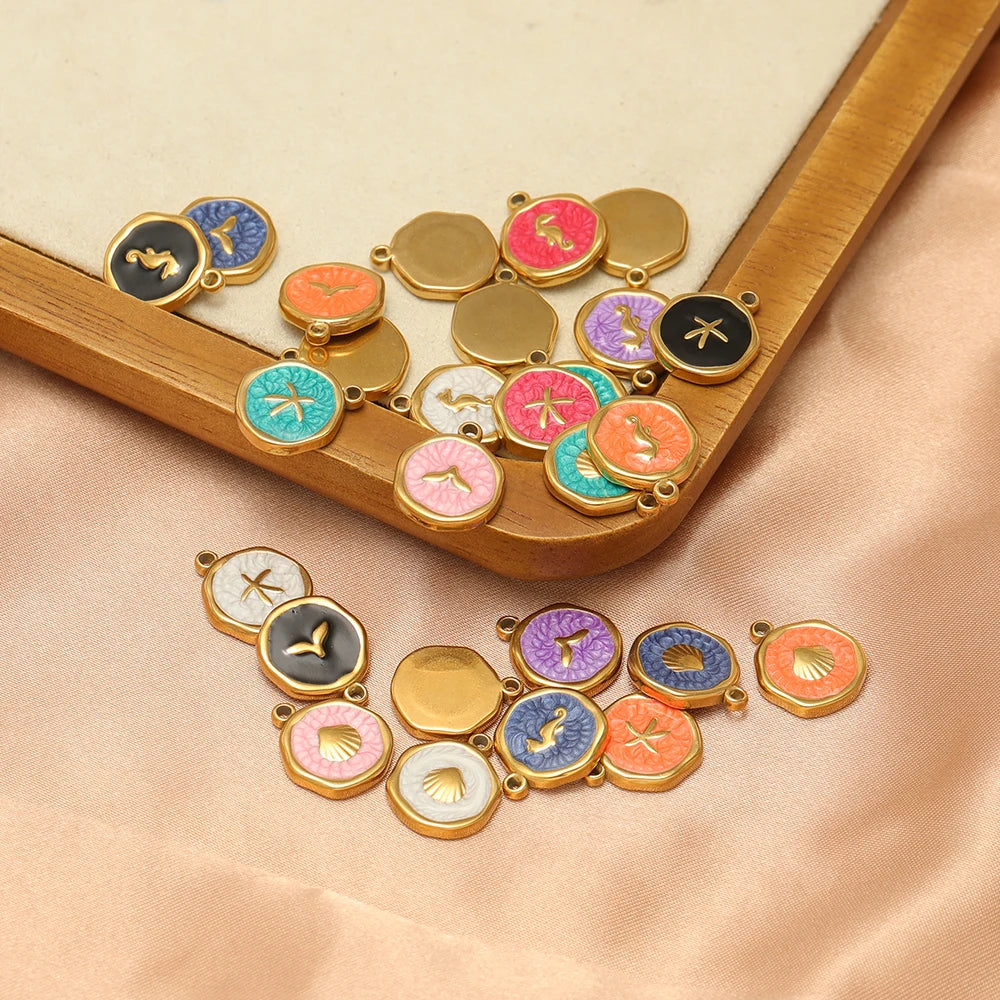 Assorted enamel animal charm pendants in gold-tone frames, various colors