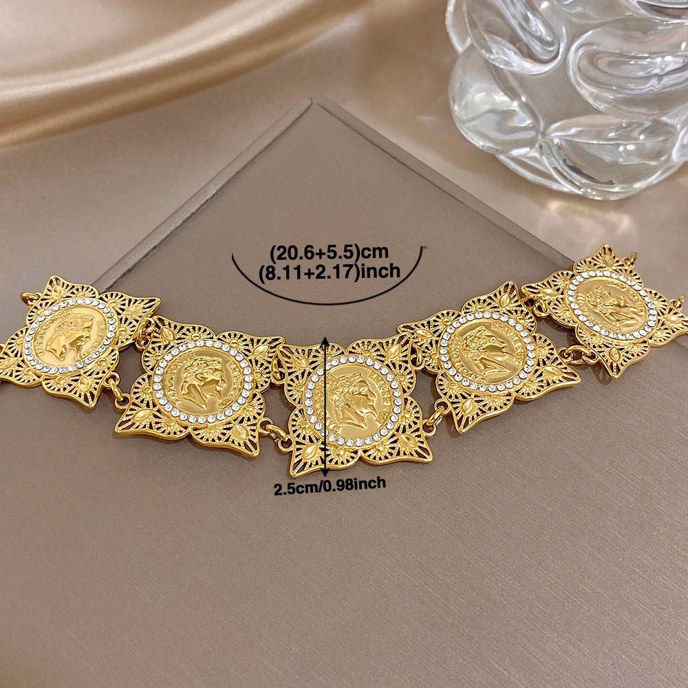 Gold-tone coin rhinestone bracelet with hollow carved links and round center medallions
