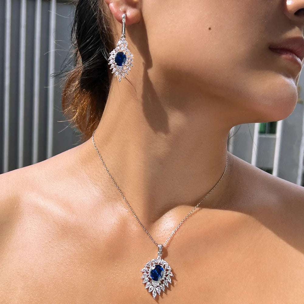 Close-up of the blue oval CZ pendant necklace and matching drop earring worn