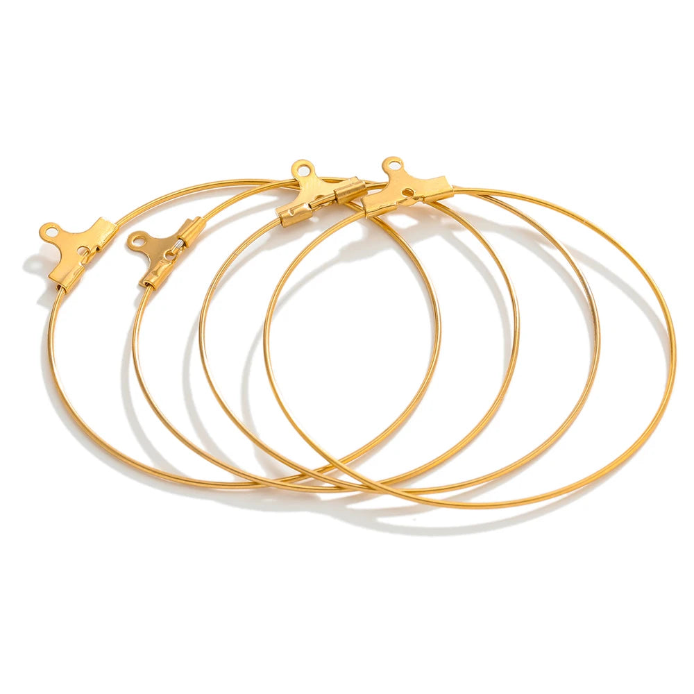 Gold hoop earring findings with clasp hooks, neatly arranged circular hoops set