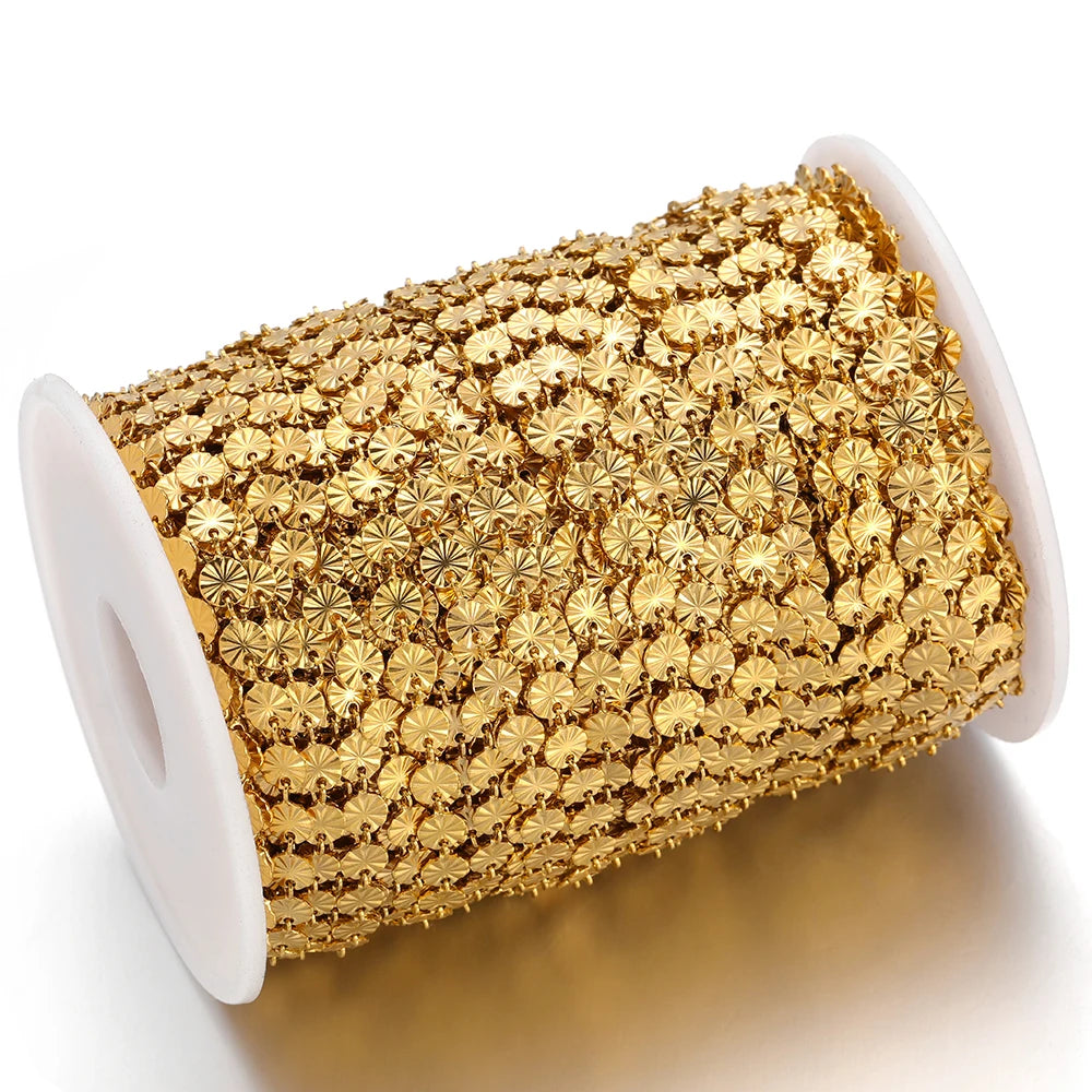 Gold heart-shaped embossed link chain on a white spool