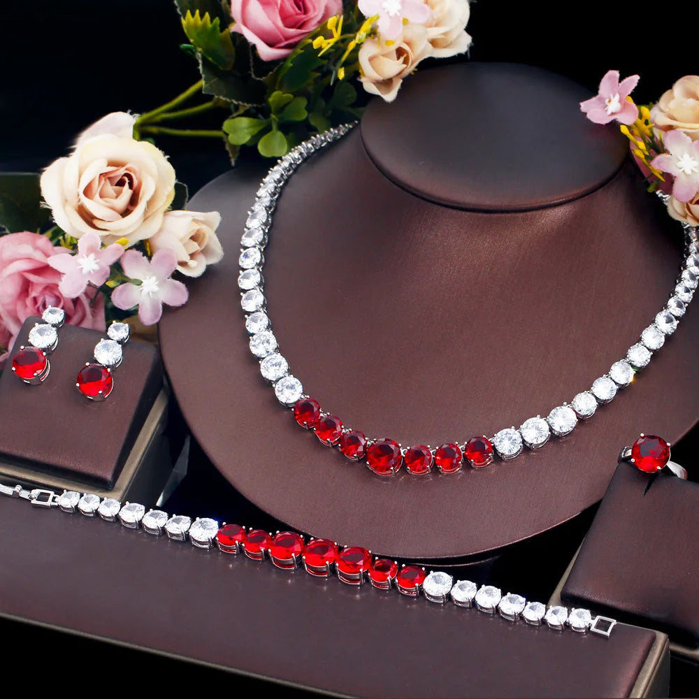 Red cubic zirconia tennis jewelry set with necklace, bracelet, ring, and matching earrings