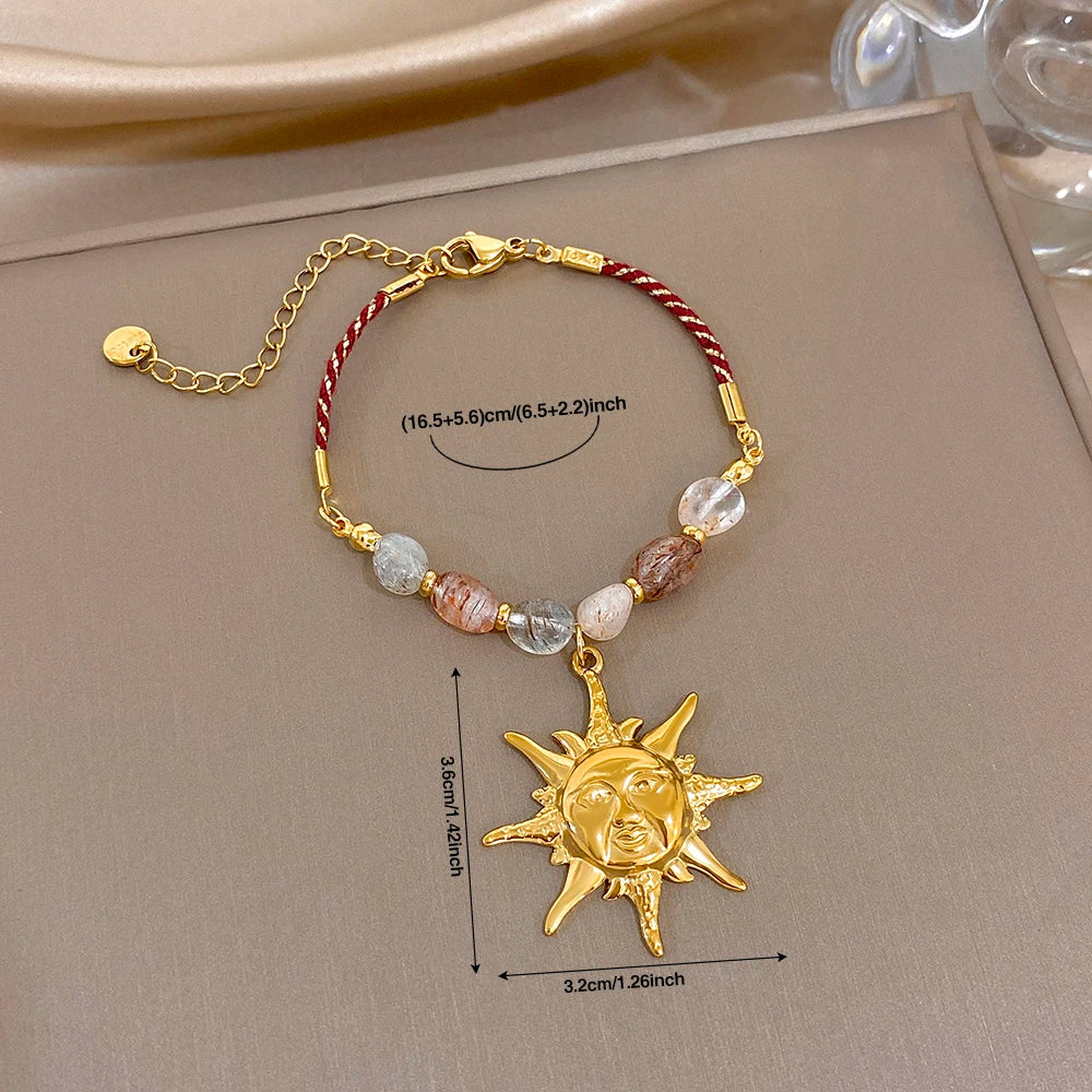 Red rope beaded bracelet with clear and peach stones and gold sun face charm pendant