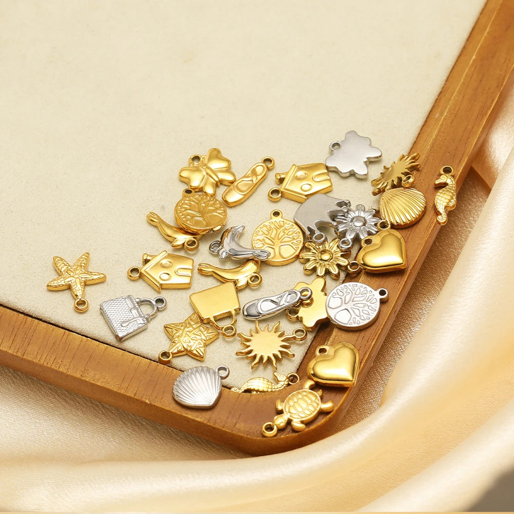 Mixed gold and silver animal, heart, star, shell, and flower pendant charms