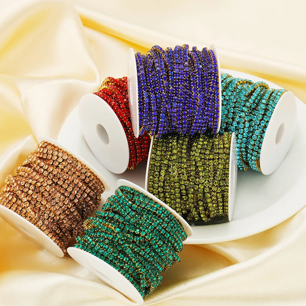 Assorted rhinestone crystal chain tassel spools in blue, red, gold, teal, and green