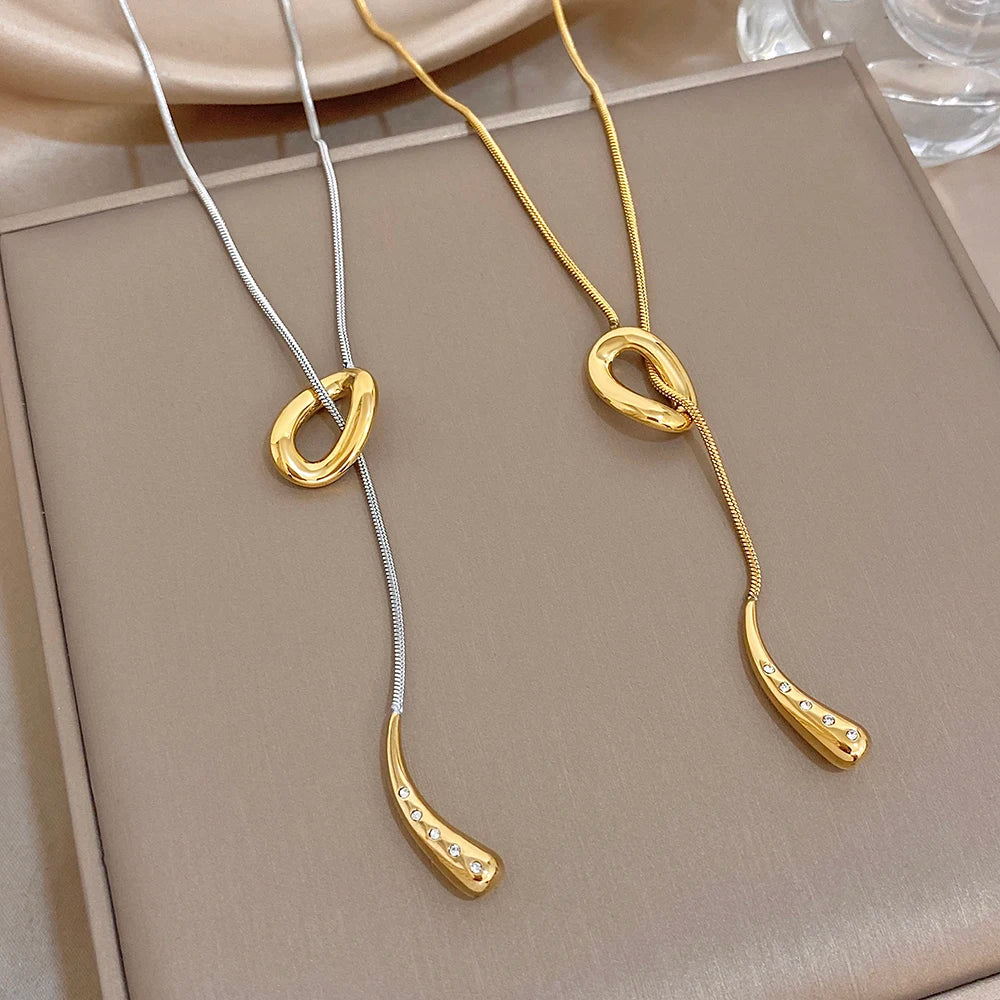 Pair of knot and waterdrop pendant necklaces with snake chains, silver and gold