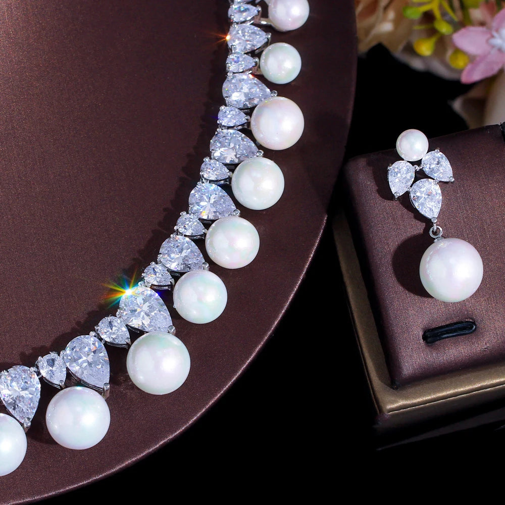 Close-up of pearl cabochon choker with rhinestone rows and dangling earrings