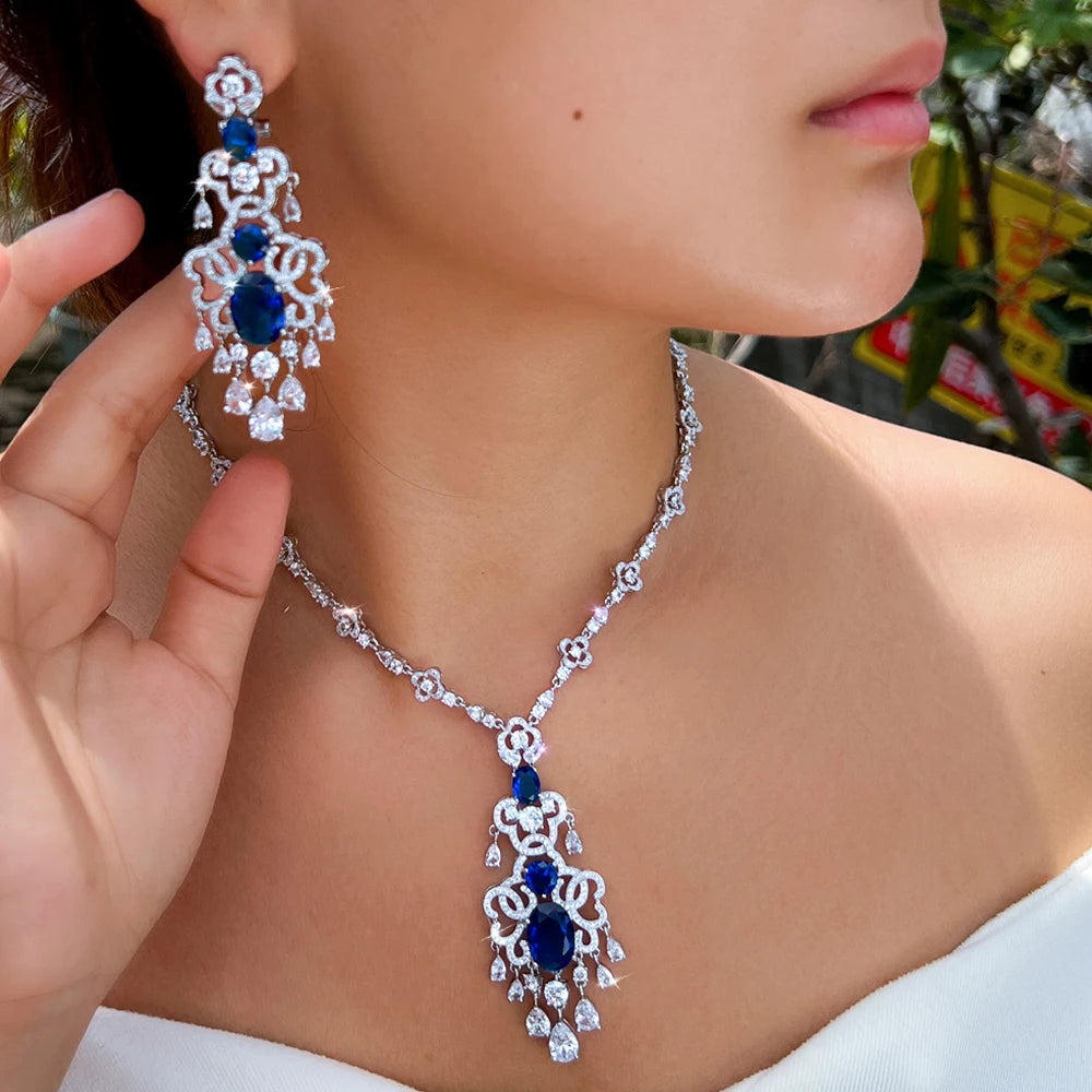 Silver-tone necklace with royal blue crystal pendant and matching chandelier earrings