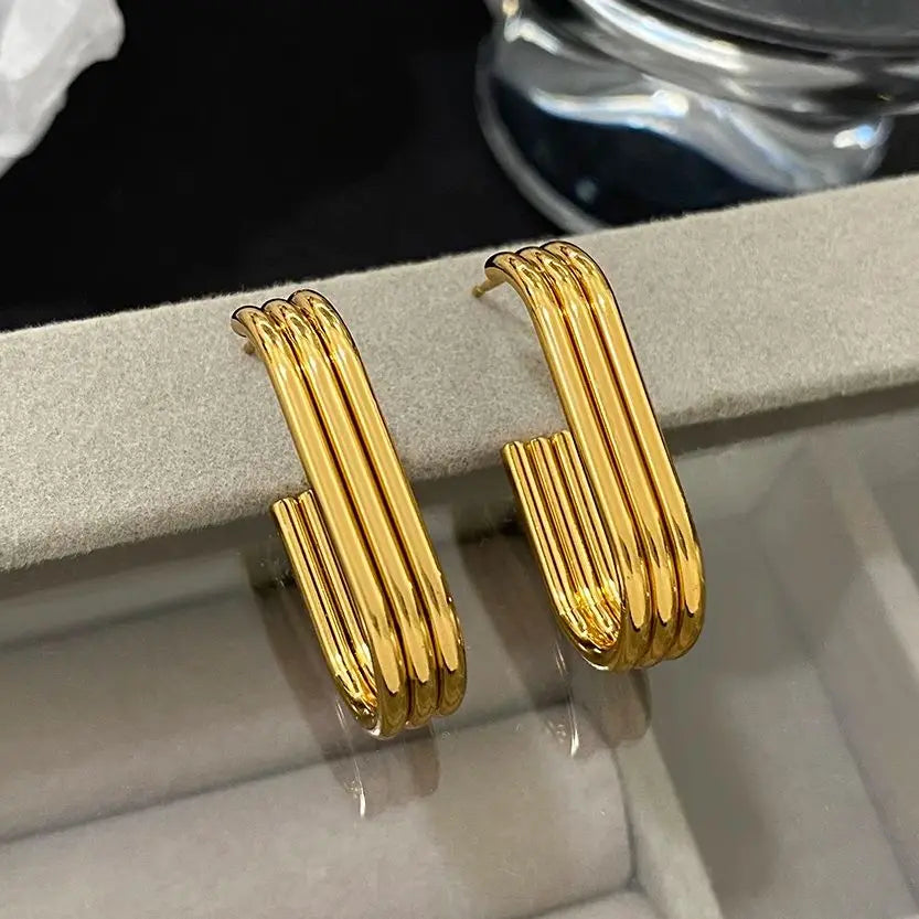 Pair of glossy gold-tone hoops with multiple parallel tubular ridges