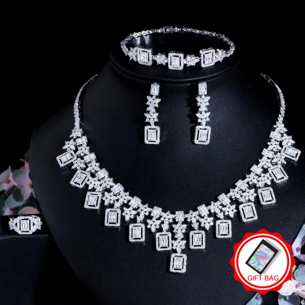 Silver-toned rhinestone jewelry set with necklace, earrings, bracelet, and ring