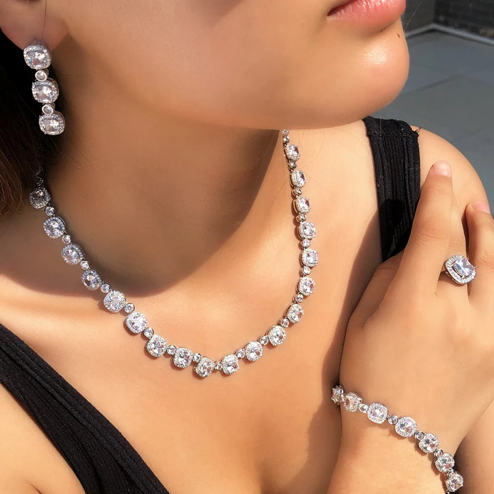 Silver-tone square cubic zirconia necklace, hoop earrings, and square ring detail