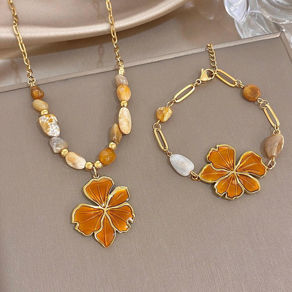 Gold plated bracelet with orange enamel flower pendant and mixed natural stone beads