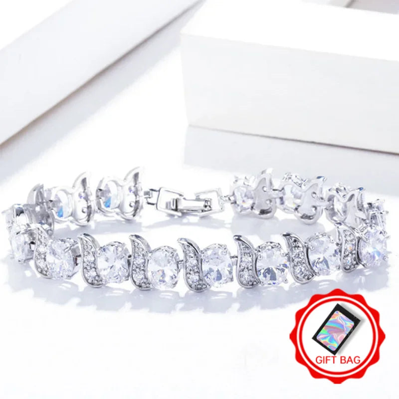 Clear oval crystal tennis bracelet with silver-tone leaf accents and clasp