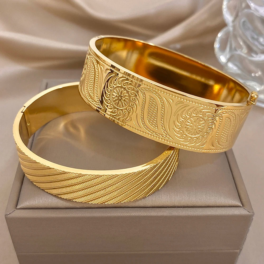 Gold-tone wide cuff bangles set with engraved floral and geometric detailing