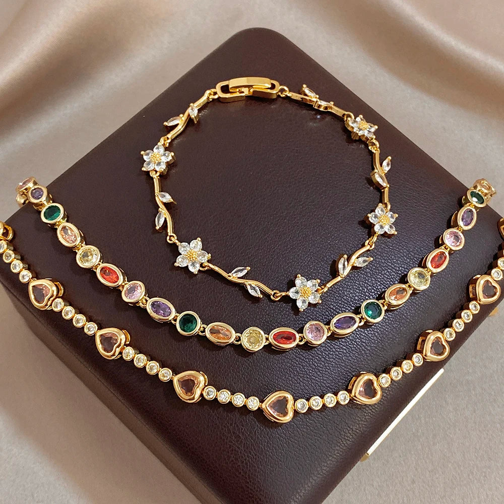 Gold-tone bracelet set with rainbow oval beads and small flower link charms