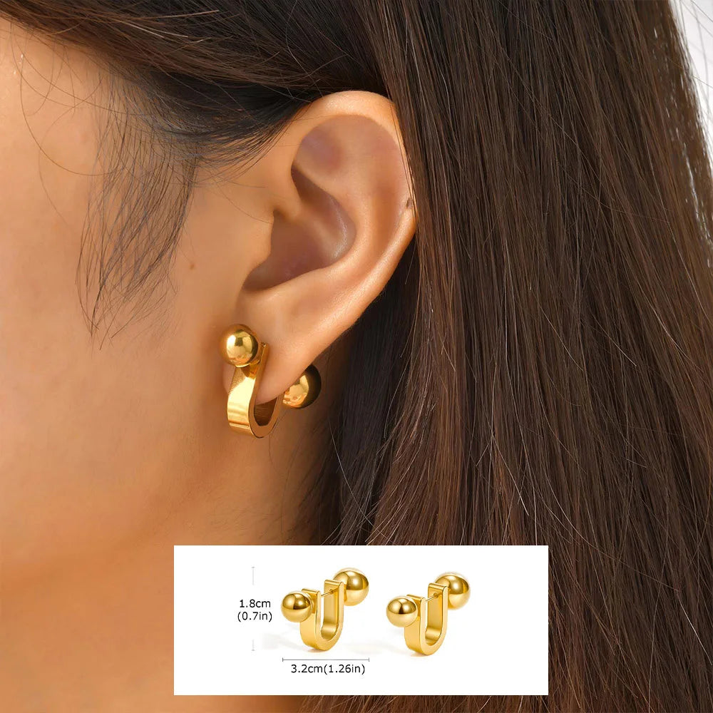 Gold-tone U-shaped hoop earrings with ball ends, shown worn