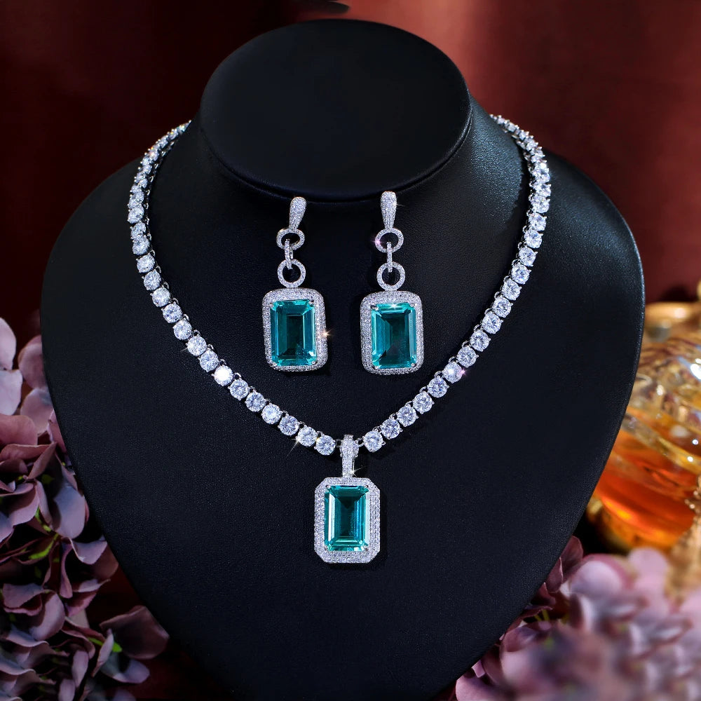 Silver-tone set: tennis necklace with rectangular teal cubic zirconia, matching earrings