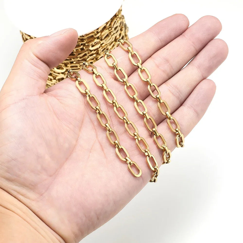 Gold square link chain draped across an open palm, showing link shape and shine