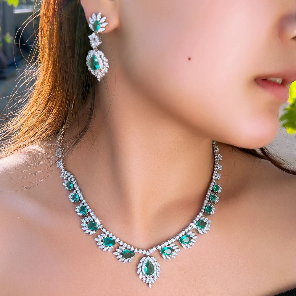 Teal and clear stone necklace with drop earrings, silver-tone floral leaf design