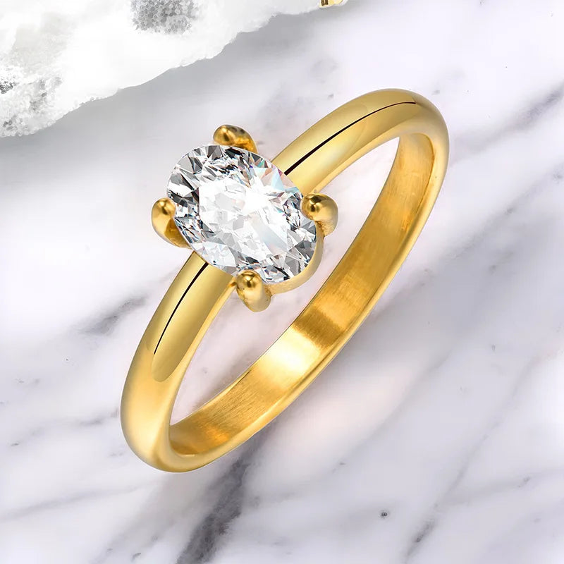 Gold-tone solitaire ring with large round cubic zirconia and heart prongs