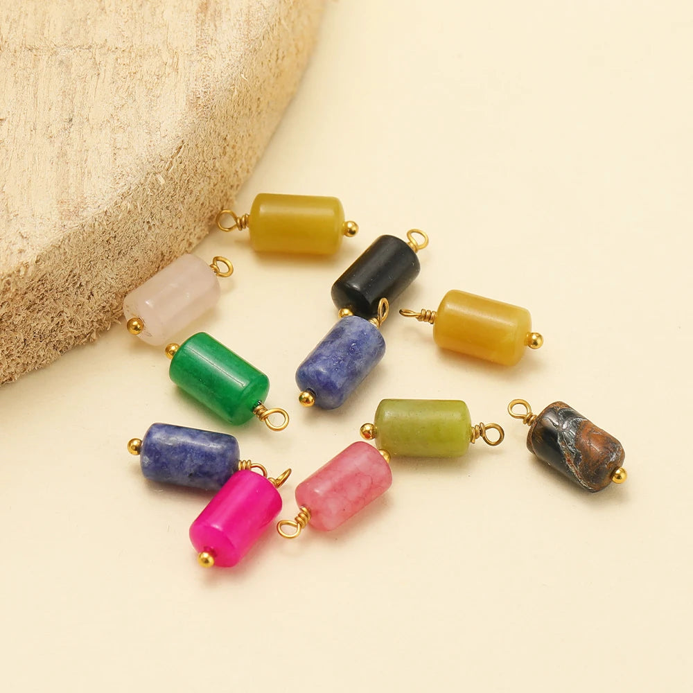 Cylinder stone charm pendants in mixed colors, gold-tone loops on each piece