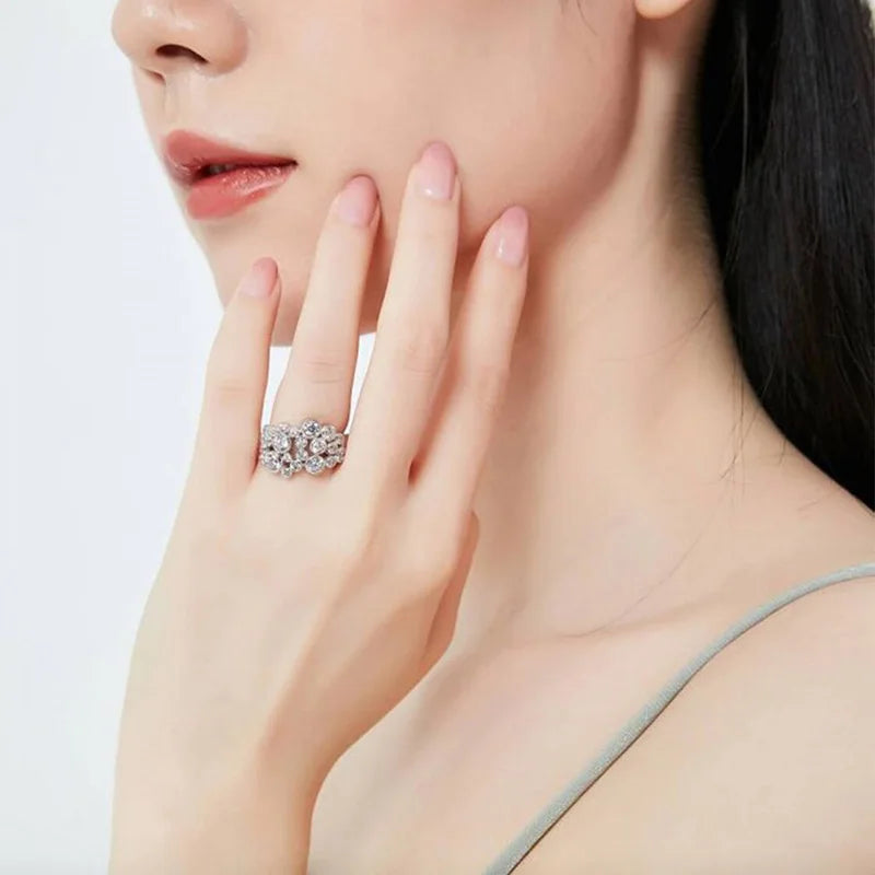 Round cubic zirconia silver ring worn on a woman’s finger