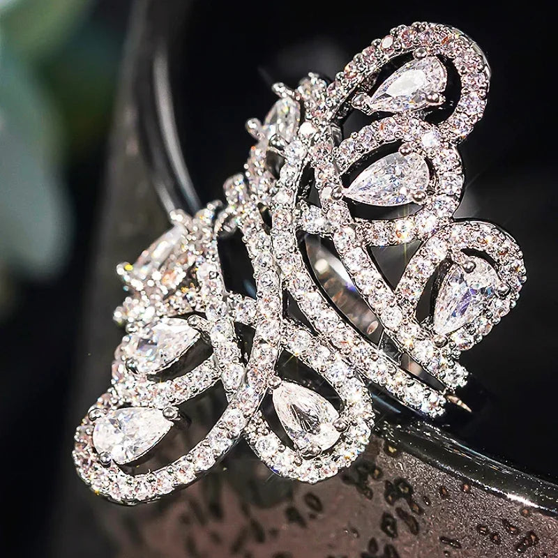 CZ cocktail ring with hollow floral pattern and teardrop-cut stones