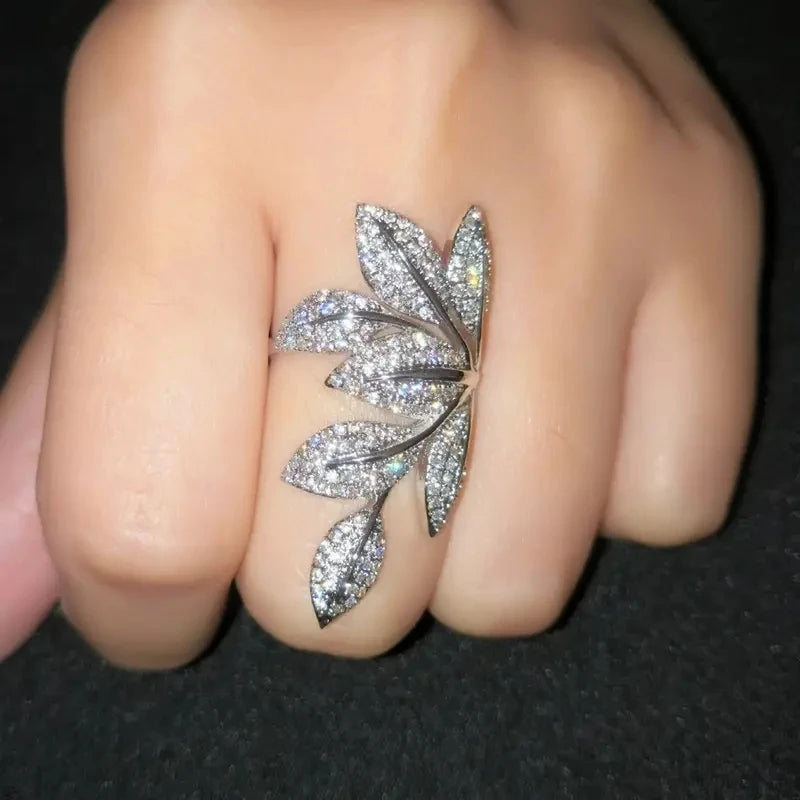 Leaf-shaped cubic zirconia ring on finger with pavé-set marquise leaves
