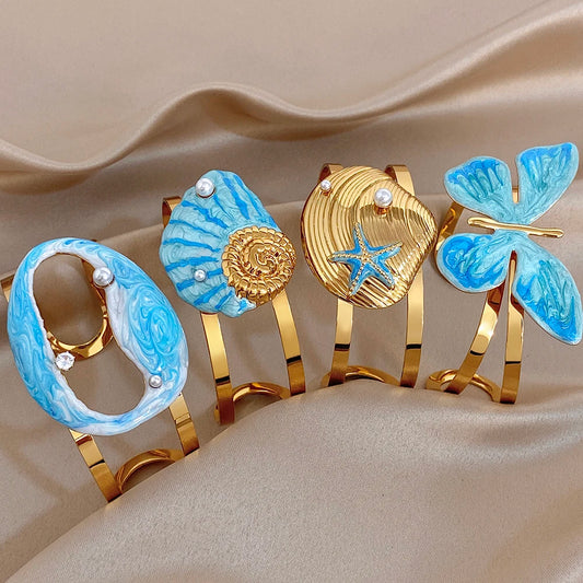 Gold-plated wide cuff bracelet with blue enamel shell and starfish details