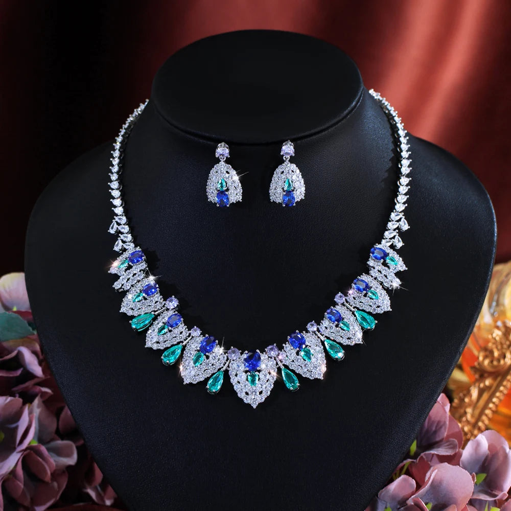 Front view of a silver-tone statement necklace and matching jeweled earrings