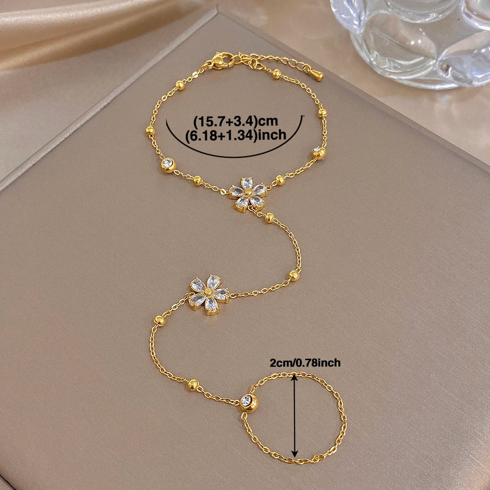 Gold-plated flower charm bracelet with connected finger ring chain