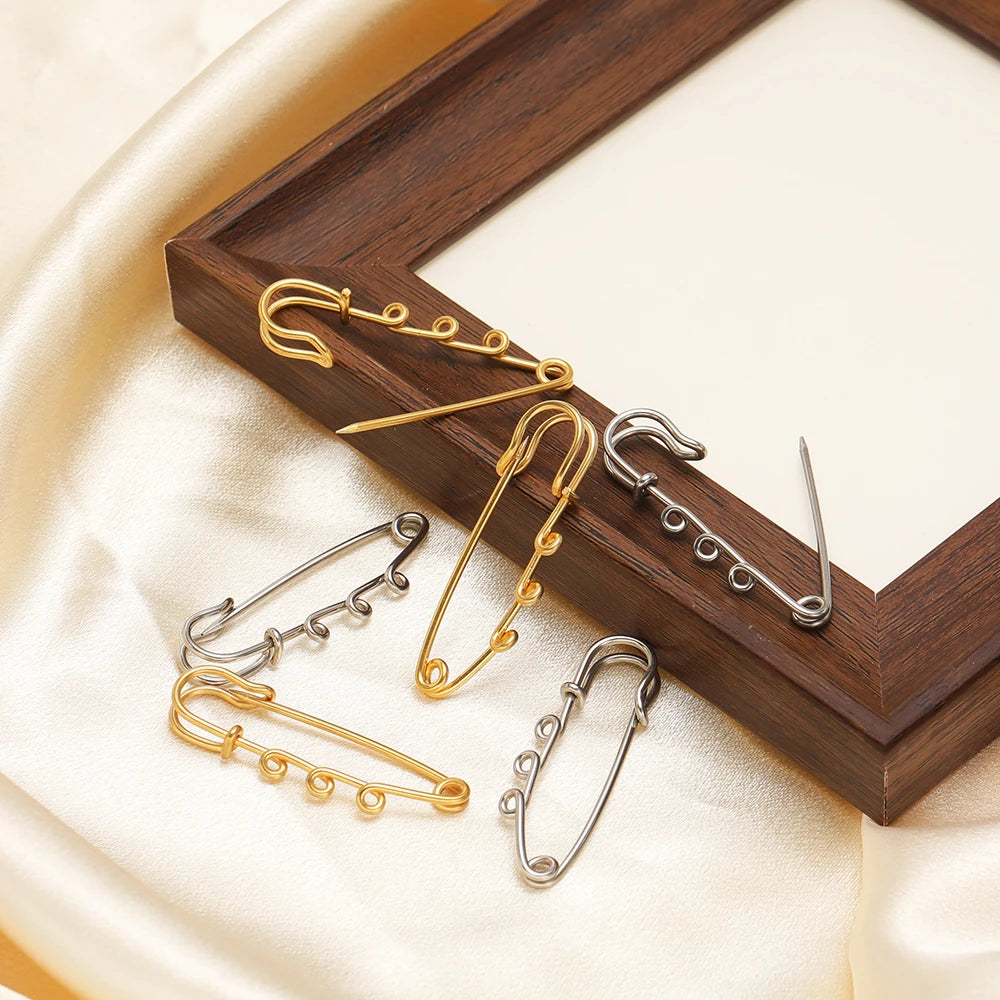 Safety pin brooch connectors set in gold and silver tones with multi-hole pins