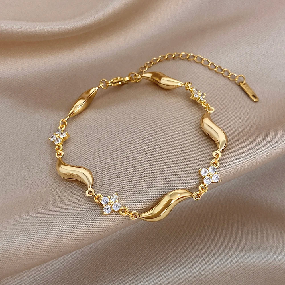 Gold-plated wave bracelet with crystal flower stones, neat circular design