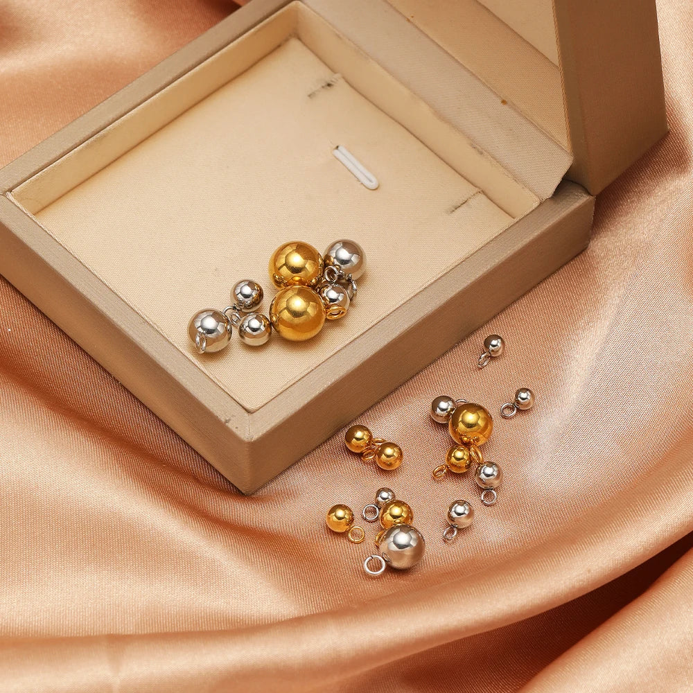 Assorted gold and silver plated ball charms with loop rings, solid spherical pendant beads
