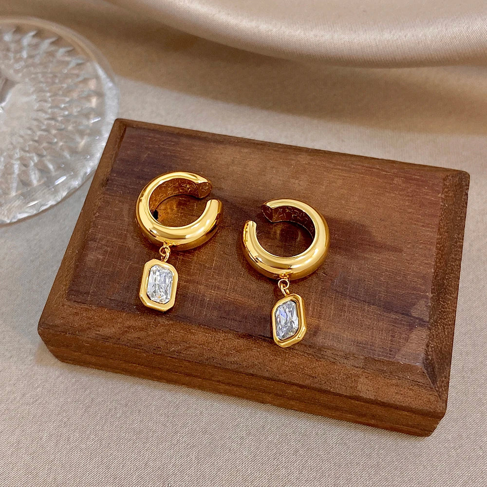 Gold-tone hoop ear clip earrings with two square crystal drops