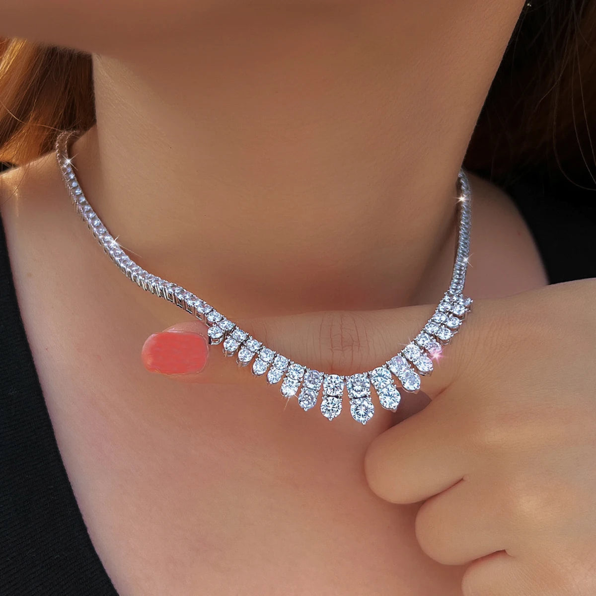 Cubic zirconia necklace with sparkling teardrop accents, shown from a close angle