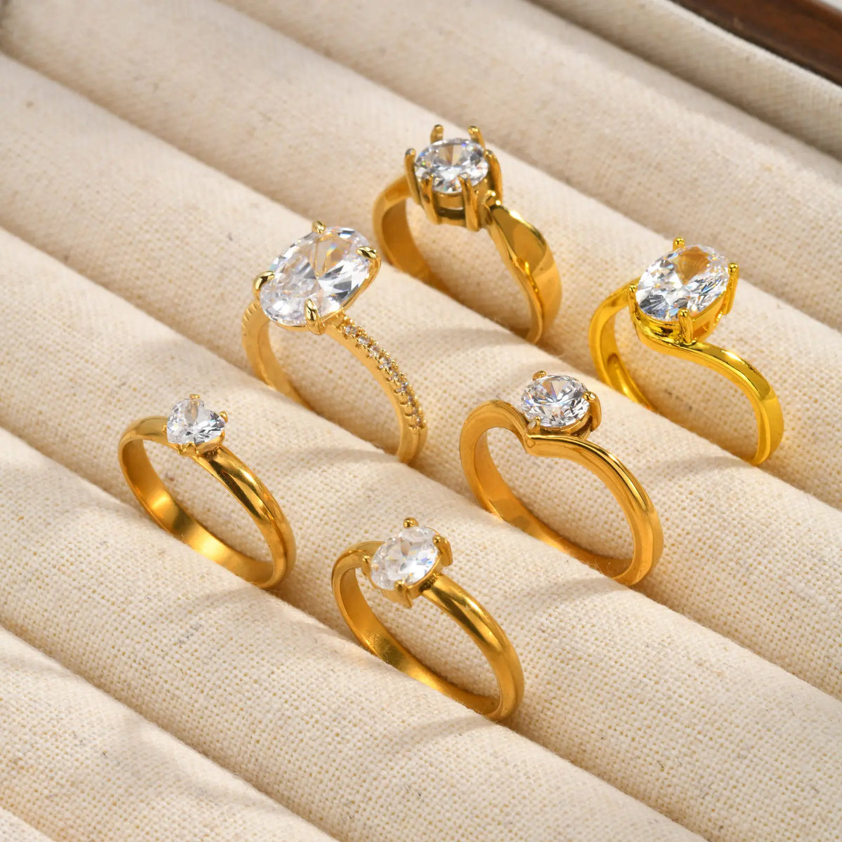 Gold-tone open-band engagement-style ring with round cubic zirconia